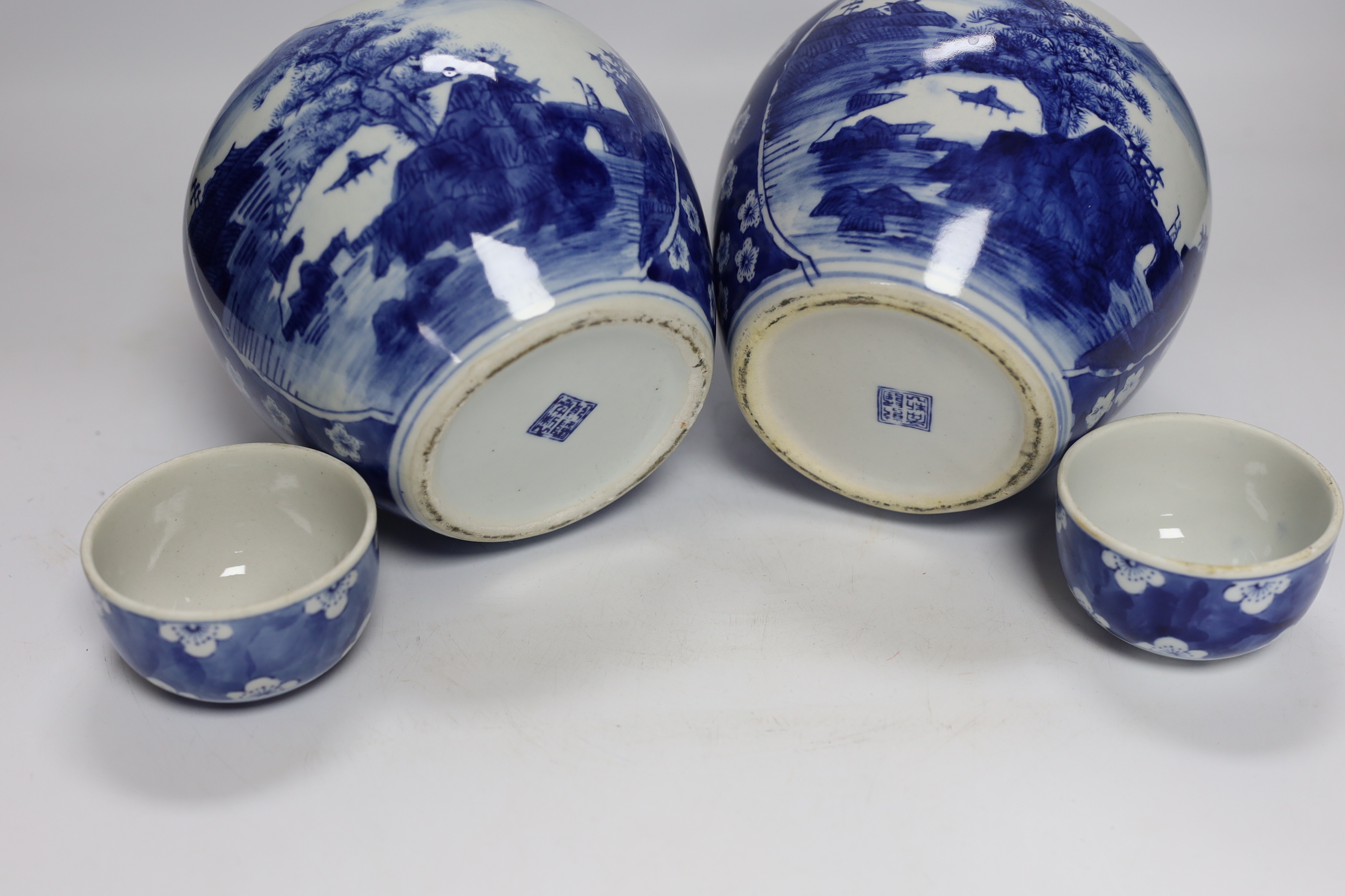 Four Chinese ginger jars, including a blue and white pair with covers and a prunus flower example, largest 21cm high